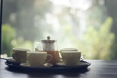 a tray with three cups of coffee on a table at Coorg Wild Walk, Nagarhole - A CGH Earth SAHA Experience in Srimangala