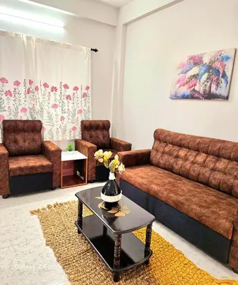 a living room with a couch and a table at Urban Suites in Coimbatore