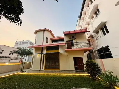 a building with a lawn in front of it at Majestic Villa 5 Bedrooms AC Bunglow in Mysore