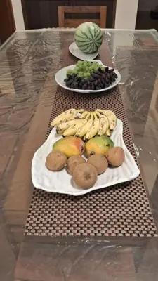 two plates of fruits and vegetables on a table at Villa Bella in Ooty