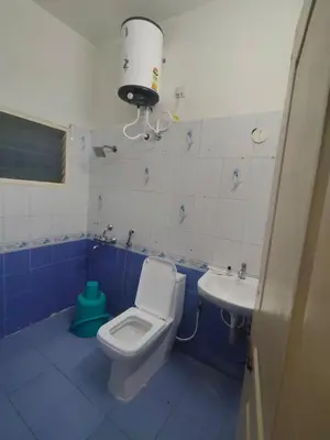 a bathroom with a toilet and a sink at Dormitory Elite in Mysore