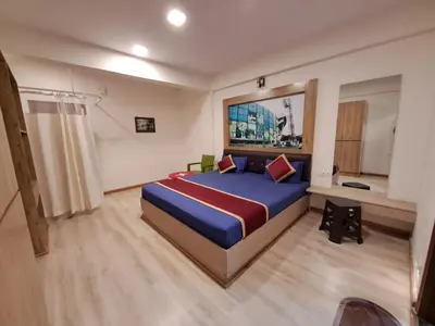 a bedroom with a blue bed in a room at Labony House in Kodaikānāl
