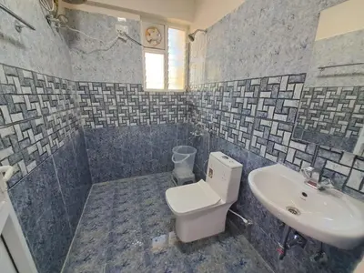 a bathroom with a toilet and a sink at Labony House in Kodaikānāl