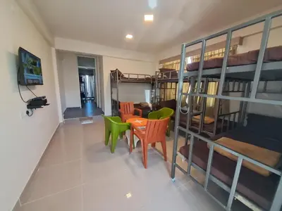 a room with a table and chairs and bunk beds at Labony House in Kodaikānāl