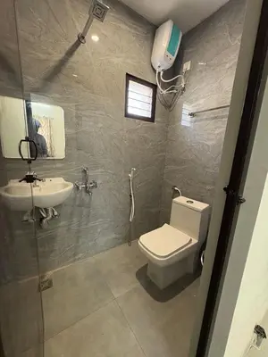 a bathroom with a toilet and a sink at TVK Grands 7 - Premium Two Bedroom Apartment in Coimbatore