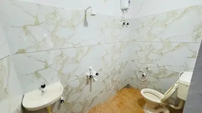 a bathroom with a toilet and a sink at StayIn-SGH near Mysore palace in Mysore