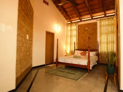 a bedroom with a bed in a room at EcoMinimalist Home by the River in Seringapatam