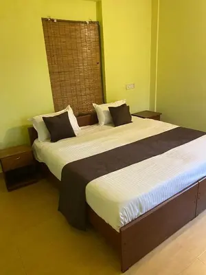 a bedroom with two beds in a room at Hazel and Oak in Vythiri