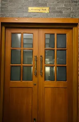 a wooden door with windows and a sign above it at Yemcee Rivera Homestay in Green Island
