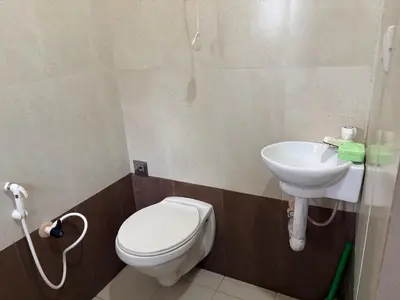 a bathroom with a toilet and a sink at Homestay Guruvayur, 1 AC & 1 Non AC bedroom in Guruvāyūr