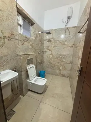 a bathroom with a toilet and a sink and a shower at Thoniyot Heritage villas in Kalpetta