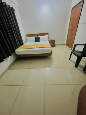 a bedroom with a bed and a chair in it at Sunrise Boutique Villa in Kozhikode