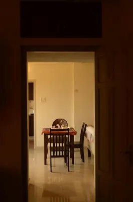 a dining room with a table and chairs in a room at 2BHK City View Calicut in Kozhikode