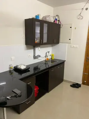 a kitchen with a black counter and a sink at Landmark world Abacus 3P in Kakkayam