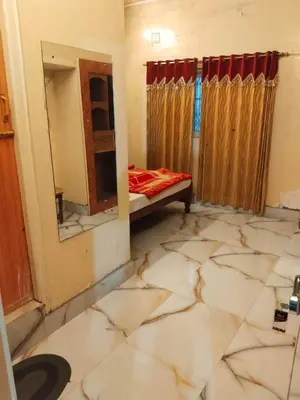 a room with a bed and a mirror at NKF Residency mysuru in Mysore