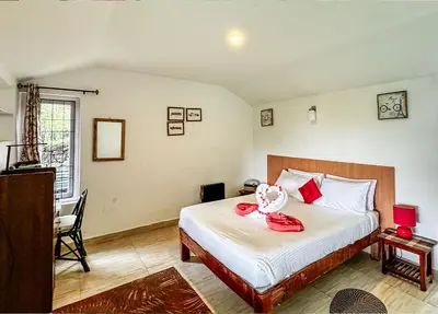a bedroom with a bed with a stuffed animal on it at Manas Valley View bungalow by Xacro Xperiences in Kodaikānāl