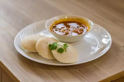 a plate with biscuits and a bowl of soup at Blue Bell Hotel in Nedumbassery