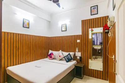 a bedroom with a bed with a wooden wall at Blue Bell Hotel in Nedumbassery