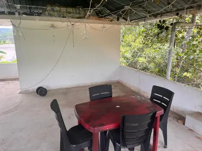 a red table and chairs sitting in a room at Safari Homestay, Malayattoor in Kodanad