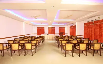 a room with a bunch of chairs and a table at Hotel Chithrapuri in Parli