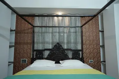a bedroom with a large bed with a canopy at Palamattam Villa Homestay,Angamaly, Kochi, Airport in Cochin