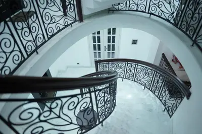 a spiral staircase with black and white railing at Palamattam Villa Homestay,Angamaly, Kochi, Airport in Cochin