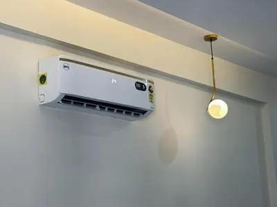 an apple monitor on a wall with a light on it at Thamarassery INN luxury and budget Rooms in Thamarassery