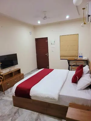 a bedroom with a large bed and a television at Thamarassery INN luxury and budget Rooms in Thamarassery