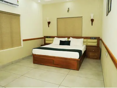 a bedroom with a large bed in a room at Aqualuxe Premium Suites in Vythiri