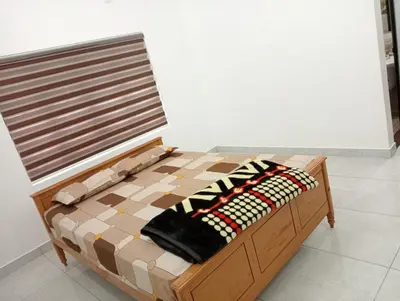 a bed with a checkerboard pattern on it at Naduthotty Holiday Home in Viripara