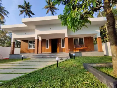 a house with a green lawn in front of it at Captain's Castle in Pallipuram