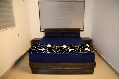 a small bedroom with a bed with a window at Blizzard Pool Villa in Padinjarathara