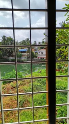 a view from a window looking out at a field at Ashirvad Homes in Mannārakkāt