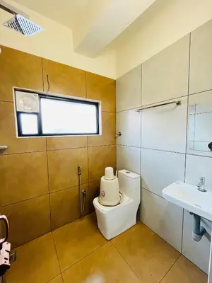 a bathroom with a toilet and a sink at Marhaba inn in Kozhikode