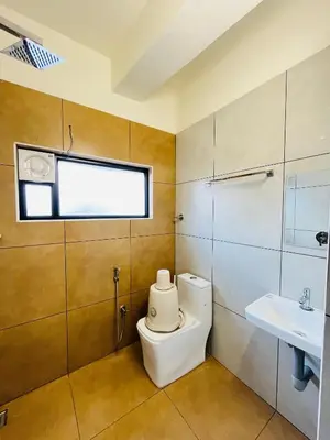 a bathroom with a toilet and a sink at Marhaba inn in Kozhikode