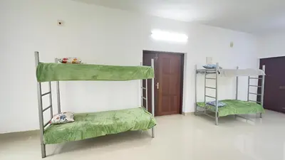 two bunk beds in a room with a door at CozyHaven in Quilāndi
