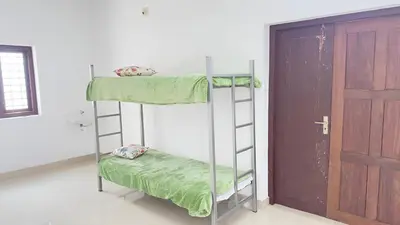 a bunk bed in a room with a door at CozyHaven in Quilāndi