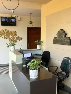 an office with a reception desk with a potted plant at AJ Wayanad Suites in Kalpetta