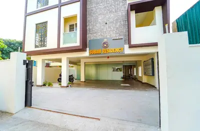an entrance to a building with a sign for a hospital at Subam Residency in Singānallūr