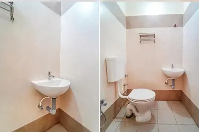 a bathroom with a toilet and a sink at Subam Residency in Singānallūr