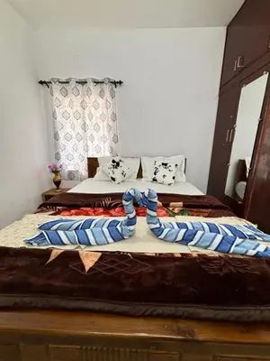 two beds in a room with two beds sidx sidx sidx at Crown Crest in Ooty