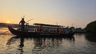 a group of people on a boat in the water at Thiruthi Homestay in Vallikunnu