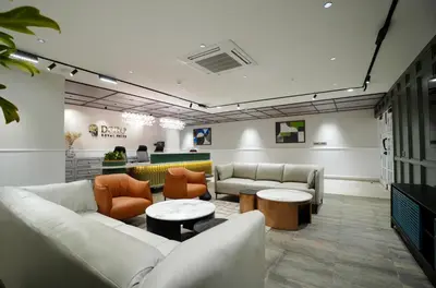 a lobby with couches and tables in a room at Doro Royal Suite in Mannārakkāt