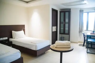 a hotel room with a bed and a table at SV Grand in Mettuppālaiyam