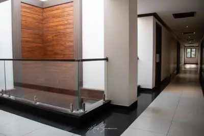 a hallway in a building with a wooden wall at SV Grand in Mettuppālaiyam