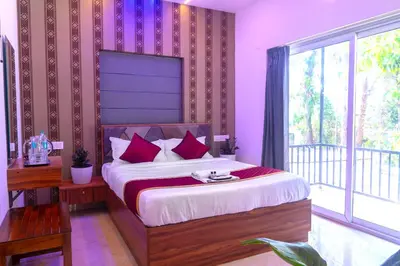 a bedroom with a bed with purple walls and a balcony at Pomma Holidays and Resorts in Muthanga