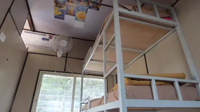a bunk bed in a room with a window at Gypsy habitat Backpackers Space in Wodapatti