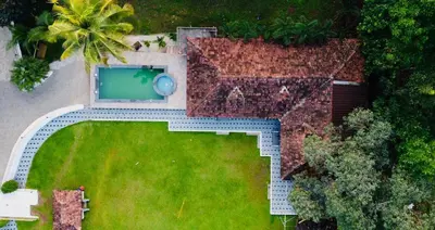 an overhead view of a garden with a swimming pool at Sparrow Vale Resort in Kotamangalam