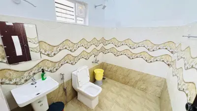 a bathroom with a toilet and a sink at mountain lake view private pool villa -Wayanad in Meppādi
