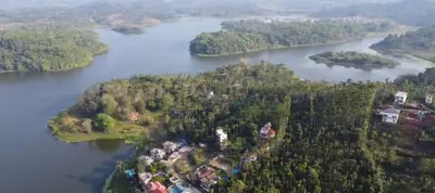 an aerial view of a house on an island in a river at mountain lake view private pool villa -Wayanad in Meppādi